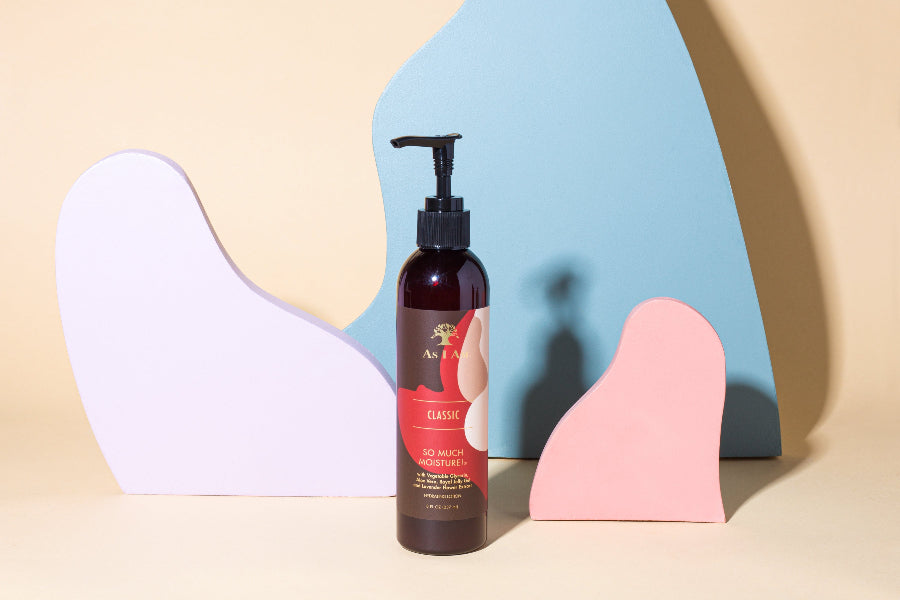 Bottle of hair product with colorful abstract shapes in the background