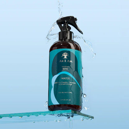 Bottle of 'As I Am' hair product with water splashing around it on a light blue background