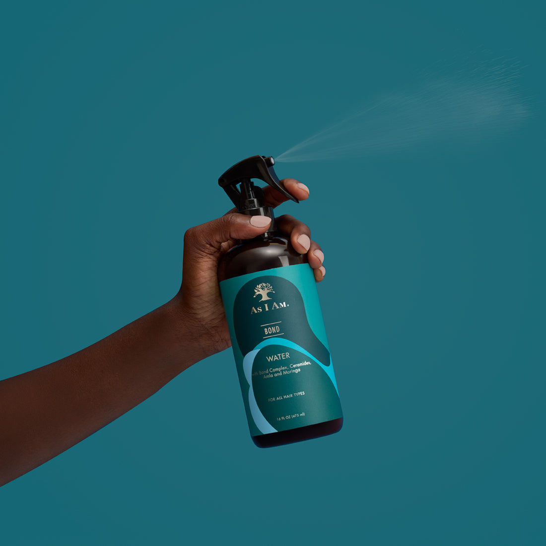 Hand holding a bottle of 'As I Am' bond water against a teal background