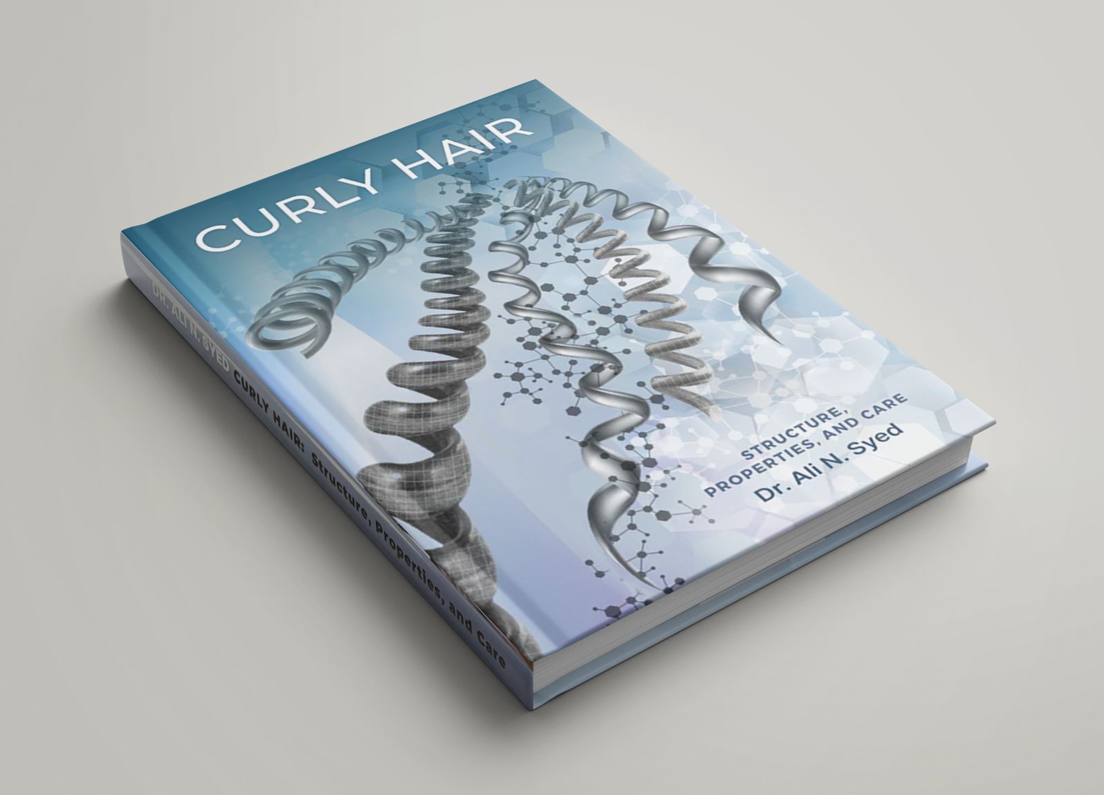 A book titled 'Curly Hair' with a blue and white cover featuring an illustration of a curly hair strand.