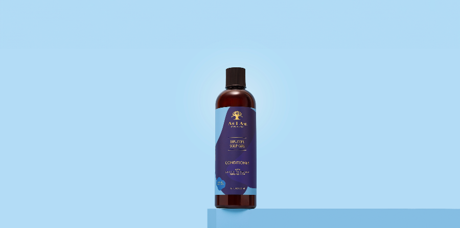 Bottle of Allure conditioner on a light blue background