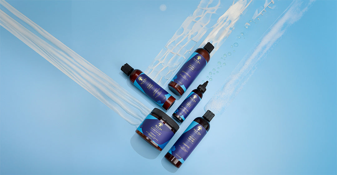 Set of blue skincare bottles with droppers on a light blue background