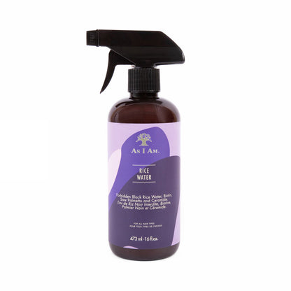 A bottle of As I Am Rice Water hair spray with a spray nozzle, predominantly purple in color with white and green label elements.
