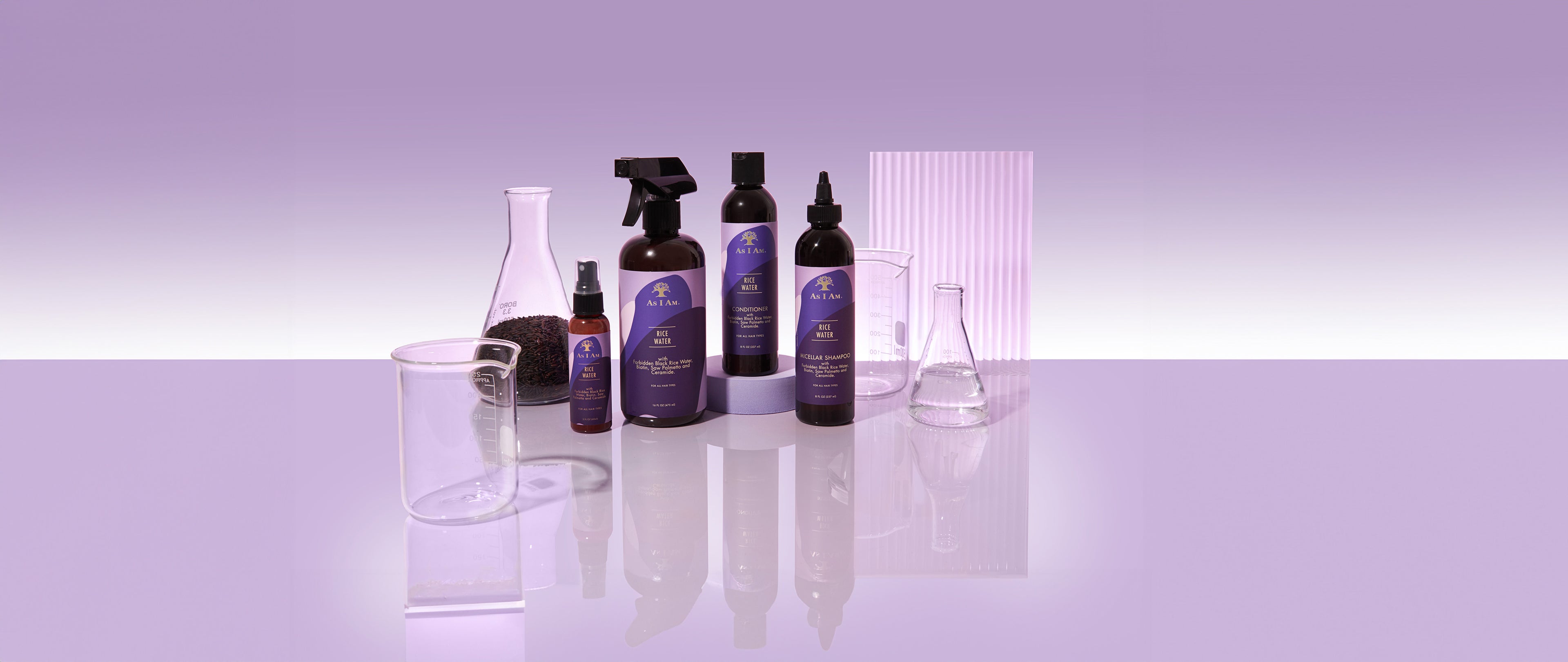Set of cleaning products on a reflective surface with a purple gradient background