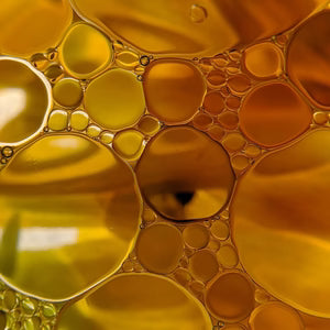 Close-up of golden bubbles in a liquid