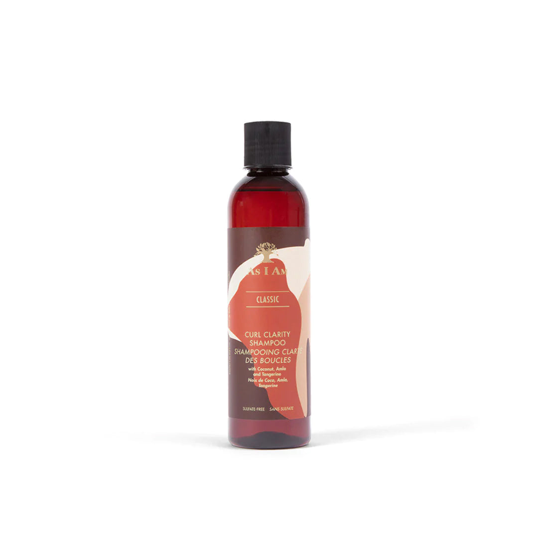 A bottle of Curl Clarity Shampoo with a label that includes the product name and mentions it is sulfate-free, suitable for color-treated hair, and enhances detangling.
