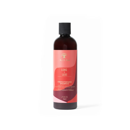 A bottle of Long & Luxe Shampoo from As I Am with a predominantly pink label and a dark cap.
